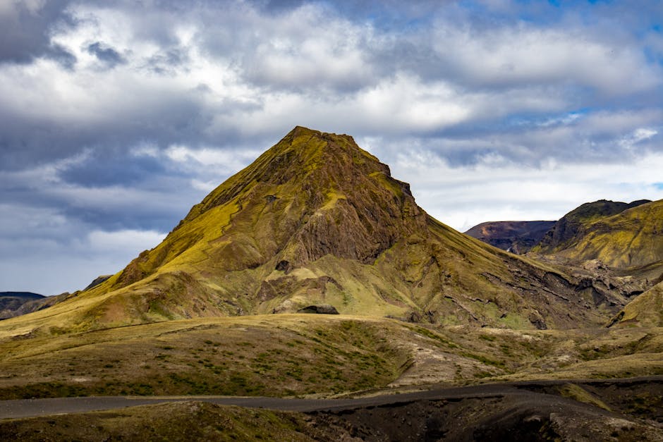 Stunning view of a rugged mountain peak under a dramatic sky in Landmannalaugar, Iceland.