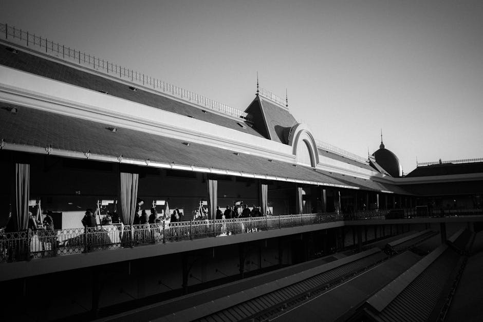 Black and white photo of a historic market building in Porto, showcasing traditional architecture and shadows.
