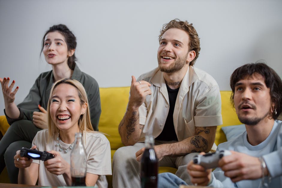A diverse group of friends smiling and playing video games on a couch.