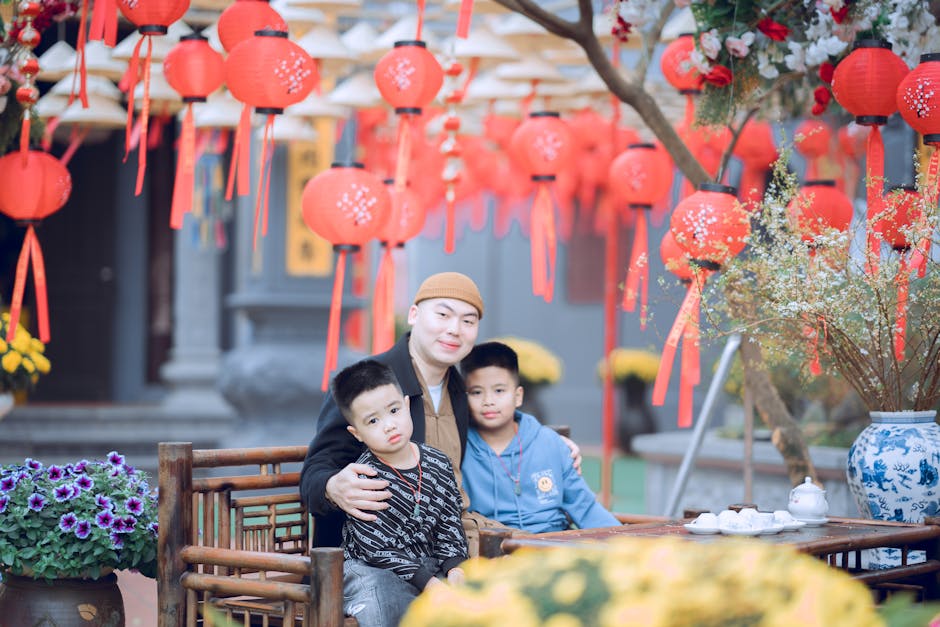 A happy family enjoying Chinese New Year under festive red lanterns.