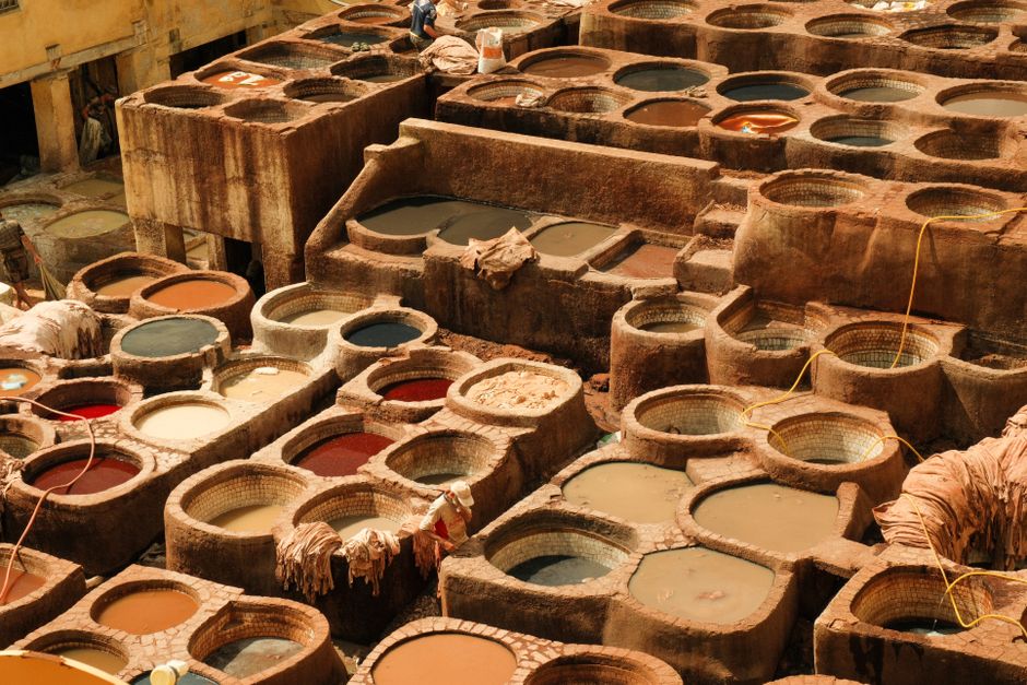 View of the traditional tannery filled with colorful dye vats in Fes, Morocco.