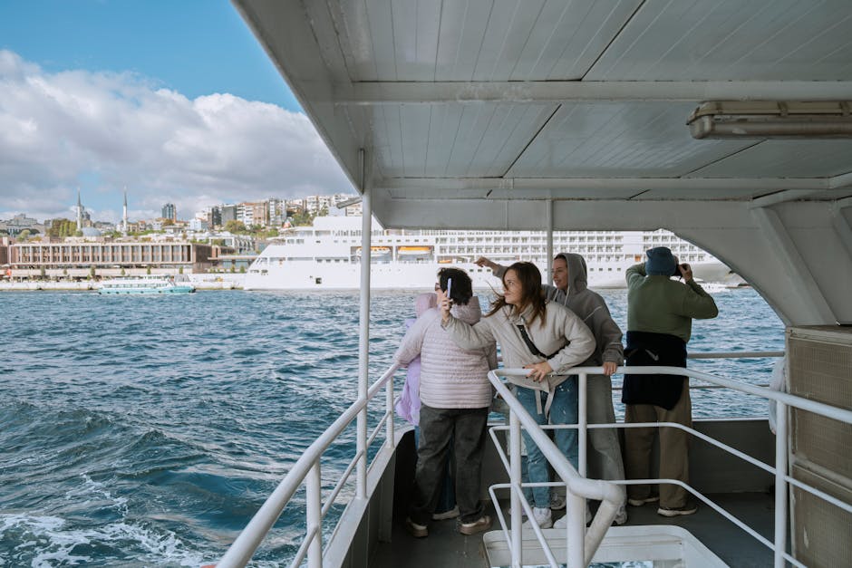 Tourists enjoy a boat ride on the Bosphorus in Istanbul with city views.