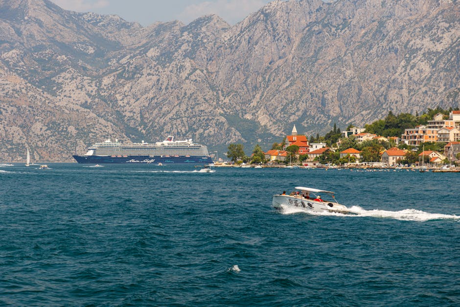 Stunning view of a Mediterranean village by the sea with a cruise ship and boats.