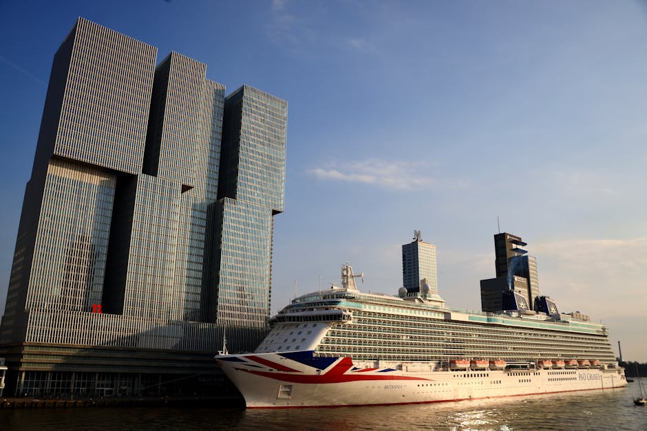 De Rotterdam towers and a cruise ship docked in Rotterdam, Netherlands.