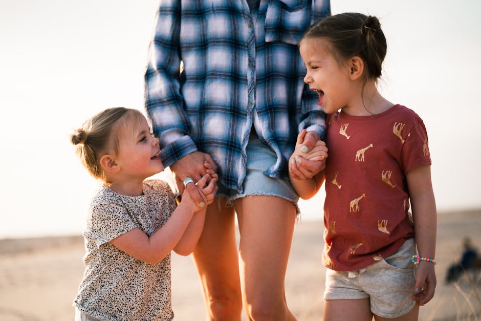 Mother and daughters enjoy a happy family walk on a sunny beach day.