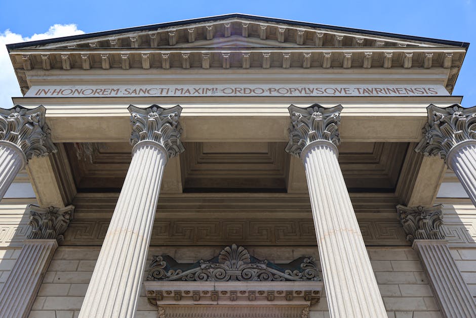 Upward view of a historic church's classical columns in Milan, Italy.